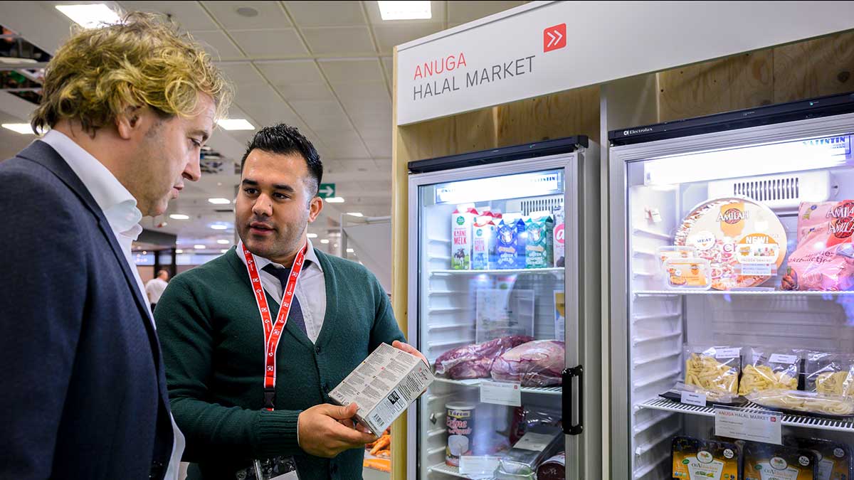 Exhibitors and visitors of the Anuga Halal Market in front of a selection of frozen products